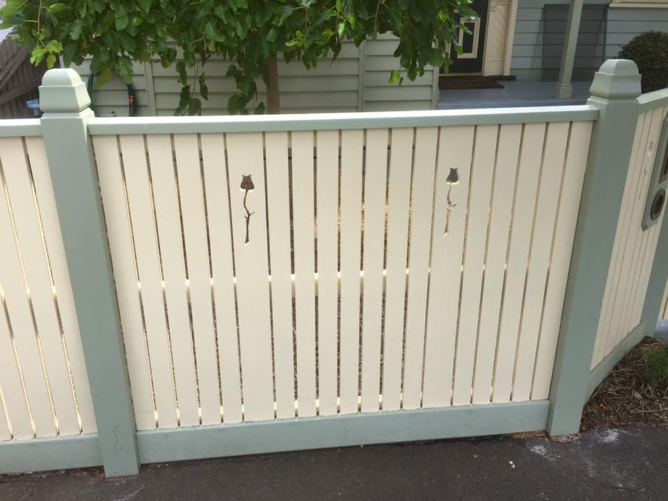 Custom painted picket fence with decorative teardrop cutouts and sage green capping