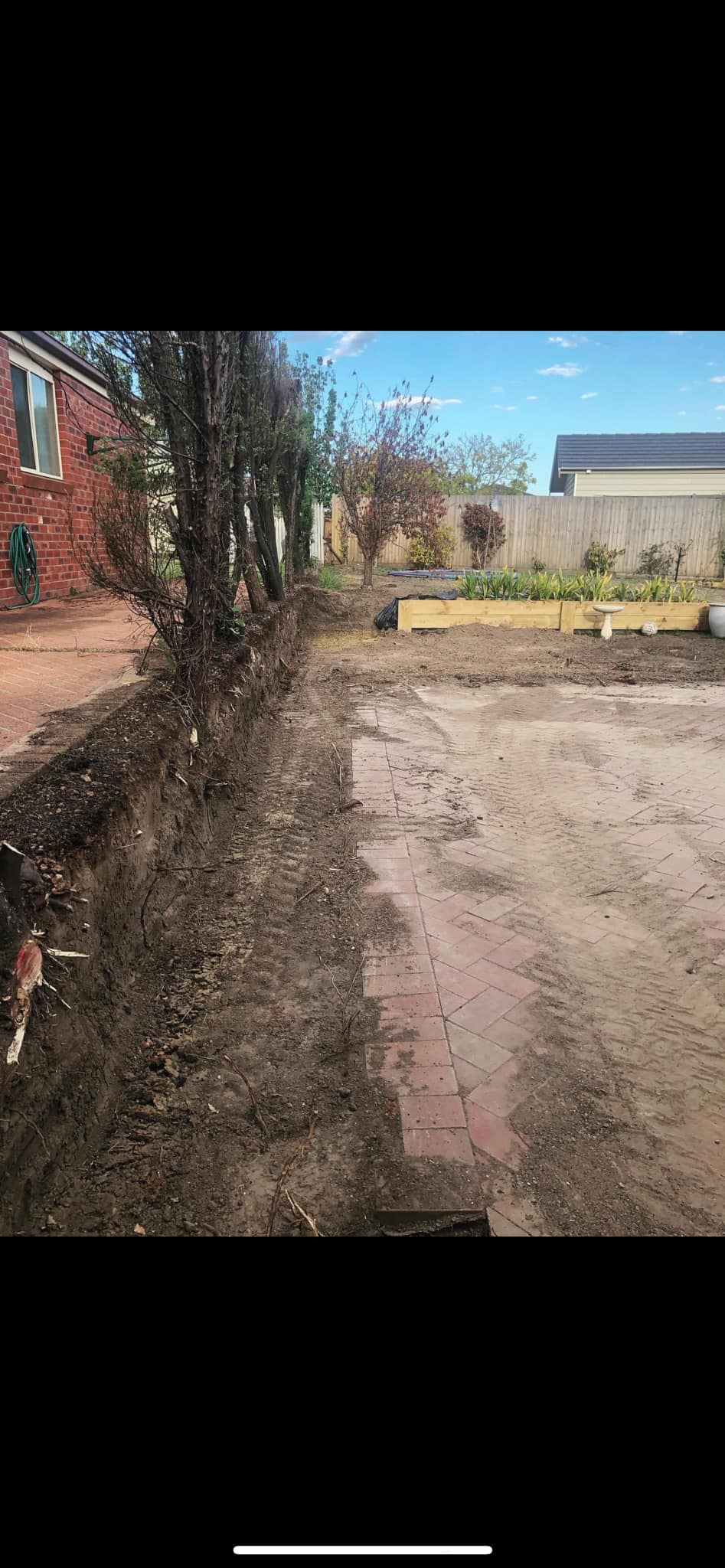 Backyard after old fence demolition, trench cleared and ready for new build